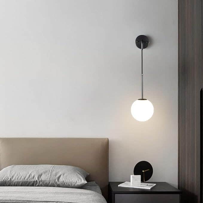Modern Black Metal Globe Wall Sconce with Adjustable Arm - Elegant Indoor Lighting