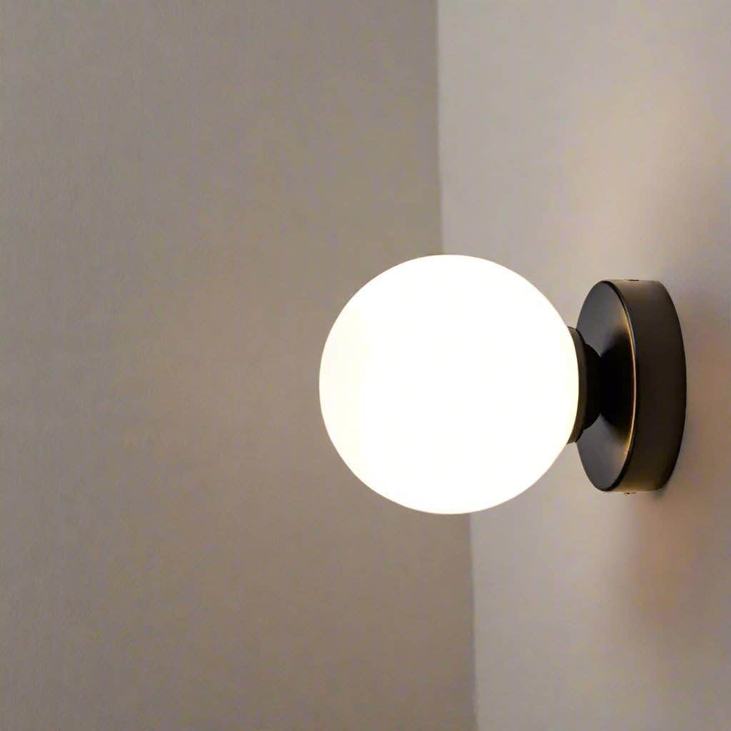 Sophisticated Modern Globe Wall Light, White Glass Shade, Black Mount